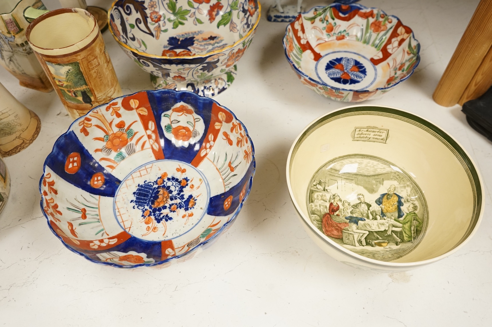 A collection of French, Japanese and English ceramics to include Royal Doulton Dickensware, Imari bowls and a faience glazed cat